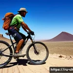 차드에서 자전거 여행 루트 - A rugged mountain bike rider traversing the vast, sun-drenched volcanic plateaus of the Tibesti regi...